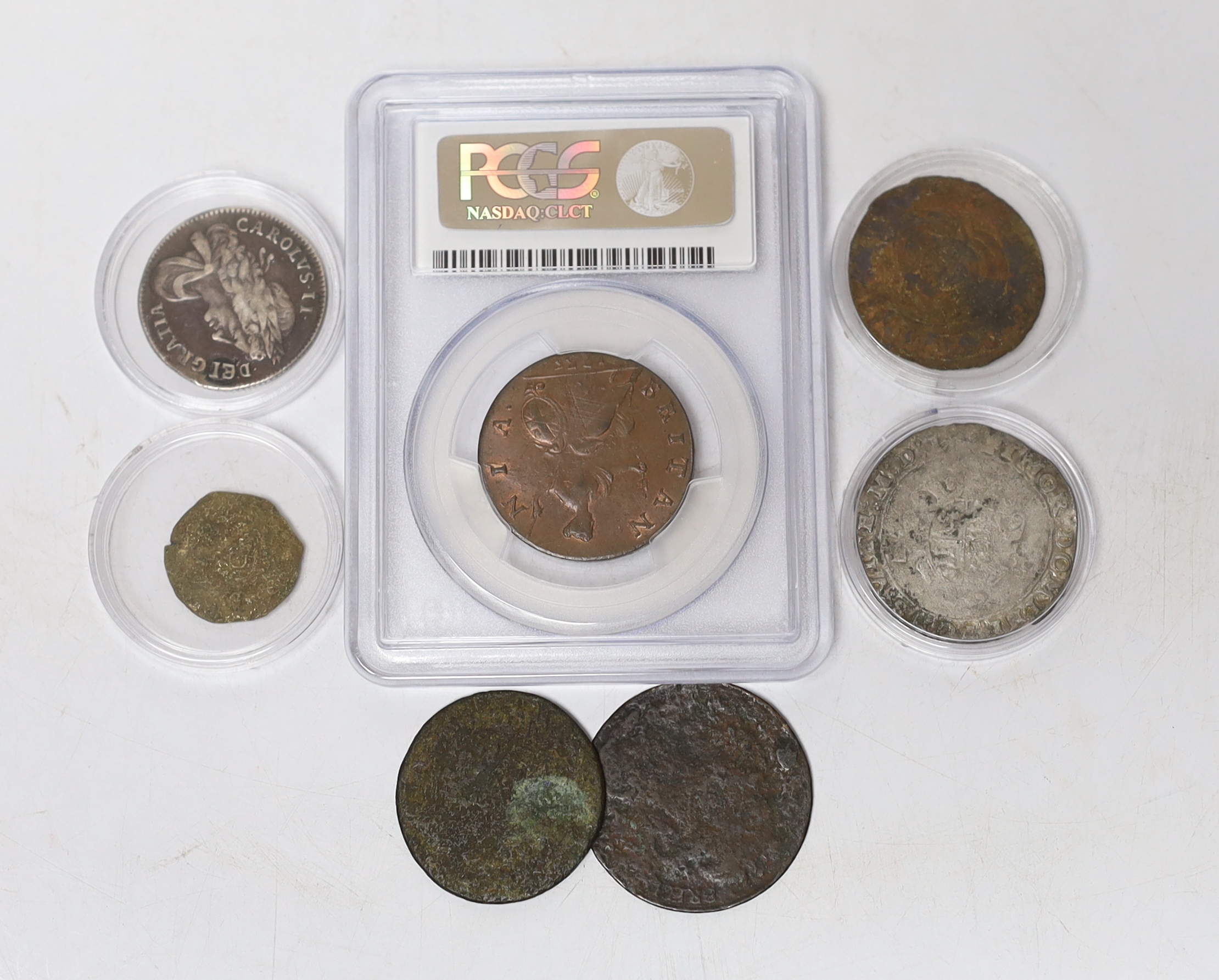 Seven coins including; a Charles II 1663 shilling, an Edward VI silver shilling, a George II 1735 half penny (PCGS graded MS65BN) together with four other coins